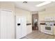 Galley kitchen with white cabinets, refrigerator, stove, and microwave at 21837 Royal St Georges Ln, Leesburg, FL 34748