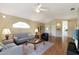 Spacious living area with hardwood floors, comfortable furniture, and a view of the backyard at 21837 Royal St Georges Ln, Leesburg, FL 34748