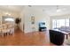 Open living room with hardwood floors, vaulted ceilings and comfy seating at 21837 Royal St Georges Ln, Leesburg, FL 34748