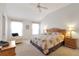 Spacious main bedroom with king-size bed and relaxing sitting area at 21837 Royal St Georges Ln, Leesburg, FL 34748