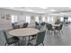 Community clubhouse meeting room with tables and chairs at 21837 Royal St Georges Ln, Leesburg, FL 34748