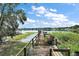 Wooden dock with bench overlooking serene lake at 2226 Dogwood Cir, Mount Dora, FL 32757