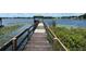 Long wooden dock extending over calm lake waters at 2226 Dogwood Cir, Mount Dora, FL 32757