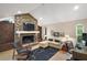 Gathering room with stone fireplace, built-in shelving and hardwood floors at 2226 Dogwood Cir, Mount Dora, FL 32757