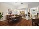 Elegant dining room with wood floors, stylish furnishings, and easy kitchen access at 2709 Astoria Ave, The Villages, FL 32162