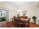 Dining room with wood floors, chandelier, and sliding door access to the outdoors at 2709 Astoria Ave, The Villages, FL 32162