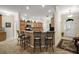 Open kitchen with counter seating, tile backsplash, and ample cabinet space at 2709 Astoria Ave, The Villages, FL 32162