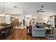 Open concept living room with hardwood floors, dining area, and breakfast bar at 2709 Astoria Ave, The Villages, FL 32162