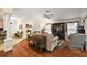 Bright living room featuring hardwood floors and a decorative entertainment center at 2709 Astoria Ave, The Villages, FL 32162