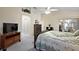 Spacious main bedroom featuring a ceiling fan, sitting area, and large windows that provide plenty of natural light at 2709 Astoria Ave, The Villages, FL 32162