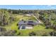 Aerial view of home shows solar panels, screened-in pool, and spacious backyard and surrounding acreage at 29319 Old Mill E, Tavares, FL 32778