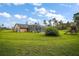 Backyard shows screened-in pool, playset, and lush lawn at 29319 Old Mill E, Tavares, FL 32778