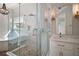 Bright bathroom featuring double vanities, a soaking tub and glass enclosed shower with marble-look tile surround at 29319 Old Mill E, Tavares, FL 32778