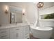 Bright bathroom featuring single vanity with a soaking tub, framed by a sunny window at 29319 Old Mill E, Tavares, FL 32778