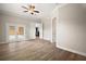 Neutral bedroom with wood flooring, double doors to outside, and an ensuite bathroom and closet at 29319 Old Mill E, Tavares, FL 32778