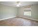 Neutral bedroom features wood-look floors and a bright window at 29319 Old Mill E, Tavares, FL 32778