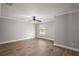 Empty bedroom boasts wood-look flooring, a ceiling fan, and white trim at 29319 Old Mill E, Tavares, FL 32778
