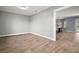 Spacious bonus room with light hardwood flooring, grey walls, and views into the kitchen at 29319 Old Mill E, Tavares, FL 32778