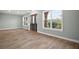 Spacious entryway with decorative front door, light green walls, and hardwood flooring with natural lighting at 29319 Old Mill E, Tavares, FL 32778