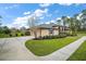 Charming single-story home featuring a well-manicured lawn, elegant landscaping, and a long driveway at 29319 Old Mill E, Tavares, FL 32778