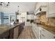Open kitchen featuring granite countertops, stainless steel appliances, and custom cabinetry at 29319 Old Mill E, Tavares, FL 32778