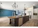 Kitchen island with granite countertop, stainless steel appliances, and modern fixtures at 29319 Old Mill E, Tavares, FL 32778