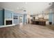 Bright open-concept living area with wood floors, fireplace, and kitchen at 29319 Old Mill E, Tavares, FL 32778