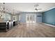 Bright open-concept living area with wood floors, kitchen island, and patio access at 29319 Old Mill E, Tavares, FL 32778
