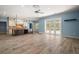 Bright open-concept living area with wood floors, island, and access to the backyard at 29319 Old Mill E, Tavares, FL 32778