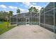 View of screened-in pool area from outdoor brick patio at 29319 Old Mill E, Tavares, FL 32778