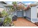 Inviting front entrance with a covered patio and blooming bougainvillea at 3201 Darien Way, The Villages, FL 32162