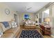 Sunroom with leather sofas, a TV, and access to a lanai at 3236 Williams Rd, The Villages, FL 32162