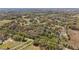 Panoramic aerial view showcasing the expansive, wooded property with scattered homes at 3380 Cr 528, Sumterville, FL 33585