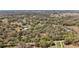 High aerial view of the property showing the surrounding treed acreage with some clearings at 3380 Cr 528, Sumterville, FL 33585
