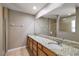 Bathroom featuring a double granite vanity, large mirror, and a separate shower at 3380 Cr 528, Sumterville, FL 33585