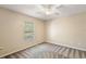 Bedroom featuring a window, ceiling fan, and neutral carpeting at 3380 Cr 528, Sumterville, FL 33585