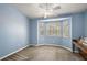 Bonus room featuring a bay window, fan and light, and neutral blue paint at 3380 Cr 528, Sumterville, FL 33585