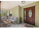 Welcoming covered front porch featuring seating for relaxing and enjoying the outdoors at 3380 Cr 528, Sumterville, FL 33585