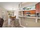 Open-concept kitchen and dining area with bar seating and backyard views at 3380 Cr 528, Sumterville, FL 33585