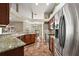 Bright eat-in kitchen offers stainless appliances, wood cabinets, granite countertops, and eat-in dining space at 3380 Cr 528, Sumterville, FL 33585