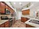 Well-equipped kitchen featuring stainless appliances, granite countertops, and wooden cabinets with stylish hardware at 3380 Cr 528, Sumterville, FL 33585