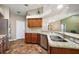 This lovely kitchen features granite counters, stainless appliances, wooden cabinets and convenient breakfast bar at 3380 Cr 528, Sumterville, FL 33585
