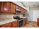 Close up of a well-equipped kitchen, featuring modern stainless-steel appliances and wood finish cabinetry at 3380 Cr 528, Sumterville, FL 33585