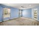Relaxing main bedroom includes a ceiling fan, two windows offering ample light, and access to the outdoors at 3380 Cr 528, Sumterville, FL 33585