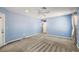 Expansive main bedroom features a ceiling fan, neutral carpeting and light blue wall paint at 3380 Cr 528, Sumterville, FL 33585