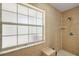 Tiled shower stall featuring a window, shower head, and built-in shelf at 3380 Cr 528, Sumterville, FL 33585
