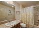Bathroom with single sink vanity, shower/tub combo and yellow floral curtain at 3764 Ivey Ter, The Villages, FL 32163