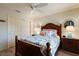 Guest bedroom with a wooden bed frame and coastal decor at 3764 Ivey Ter, The Villages, FL 32163