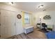 Entryway with wood-look floors, bench, and workspace at 3764 Ivey Ter, The Villages, FL 32163