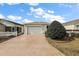 House exterior with attached garage and white picket fence at 3764 Ivey Ter, The Villages, FL 32163
